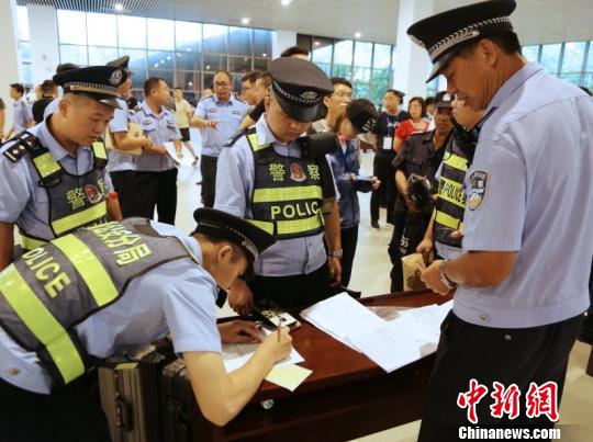 图为警方在登记涉传人员资料 劳运荣 摄